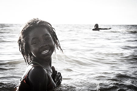 grayscale photo of two girl on body of water thumbnail