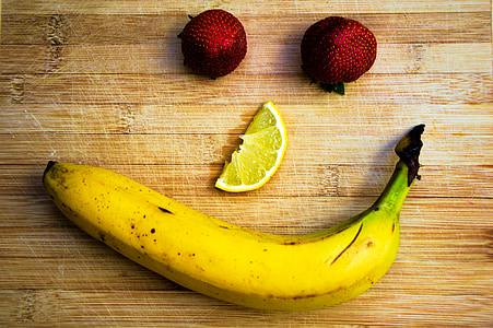 strawberry eye, lemon slice, and banana smile on wooden board thumbnail