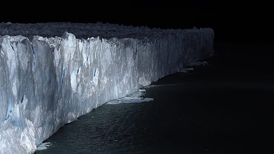 iceberg on ocean at night thumbnail