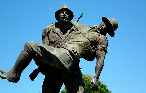 man carrying man statue at daytime thumbnail