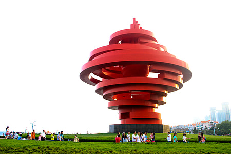 people standing near red architectural spiral tower thumbnail