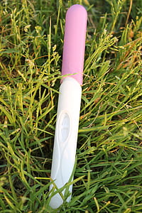 white and pink pregnancy kit on grass thumbnail