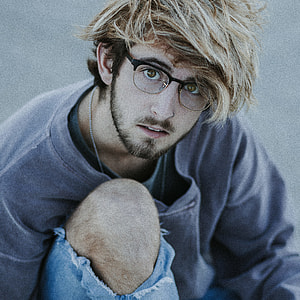 man sitting on concrete floor thumbnail