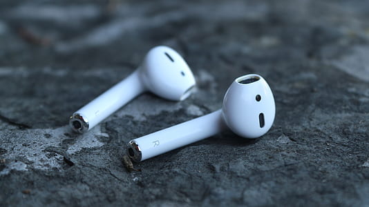pair of white Air Pods on concrete surface thumbnail