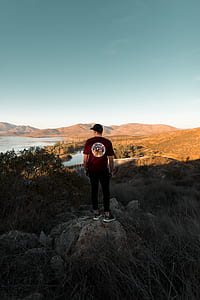man standing on brown stone thumbnail