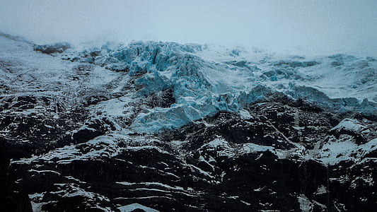 photo of white and brown mountain range covered with snow thumbnail