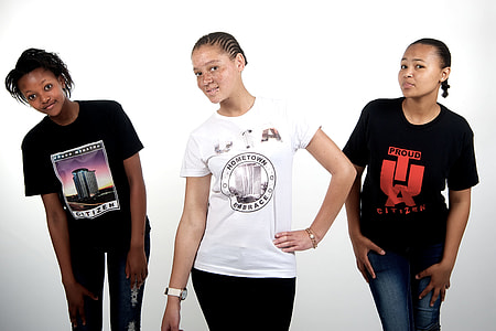 three women wearing white and black printed crew neck shirts thumbnail