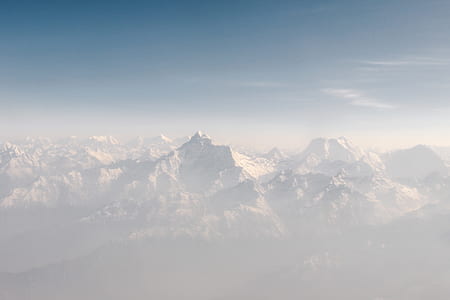 snowy mountain covered with fog thumbnail