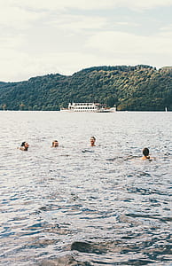 four people on water during daytime thumbnail
