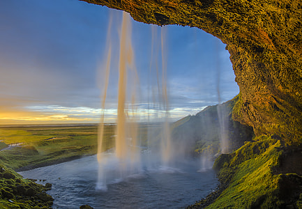 timelapse photography of flowing waterfall during golden house thumbnail