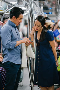 Man Wearing Blue Button-up Dress Shirt Holding Smartphone thumbnail
