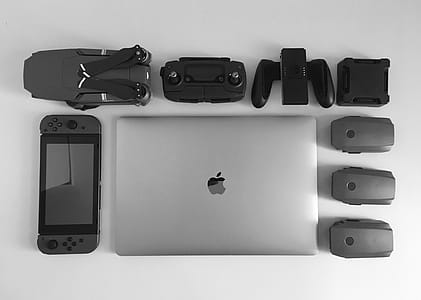 Silver Macbook Surrounding Black Electronic Devices thumbnail