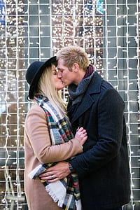Kissing Couple With Holiday Lights Photo thumbnail