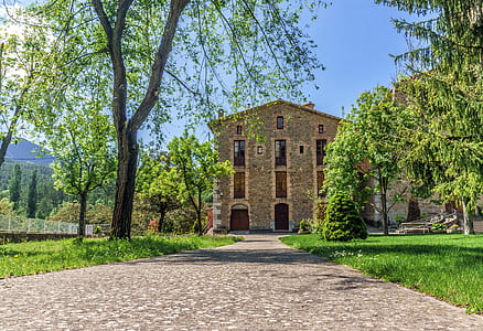 brown 4-storey building surrounded by trees thumbnail