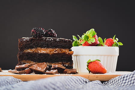 closeup photo of sliced cake with strawberry on brown ceramic plate thumbnail