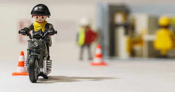 selective focus photography of man riding motorcycle toy thumbnail