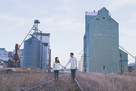 man and woman standing on green grass thumbnail