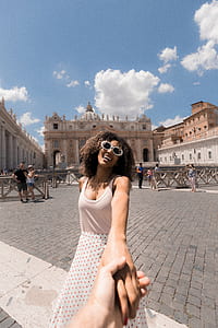 woman in white tank top holding hand thumbnail
