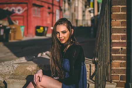 woman sitting on brown concrete stairs thumbnail