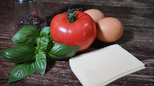 tomato beside two organic eggs thumbnail
