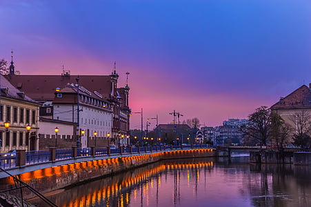 white and brown buildings near body of water thumbnail