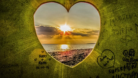 heart shape frame through body of water during sunset thumbnail