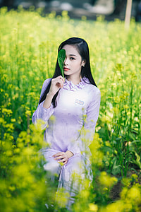woman in pink pajama set holding green leaf covering eye surrounded by green plants during daytime thumbnail