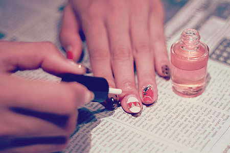 woman applying nail polish on hands thumbnail