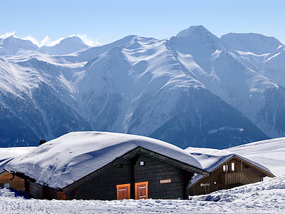 brown wooden house covered with snow at daytime thumbnail