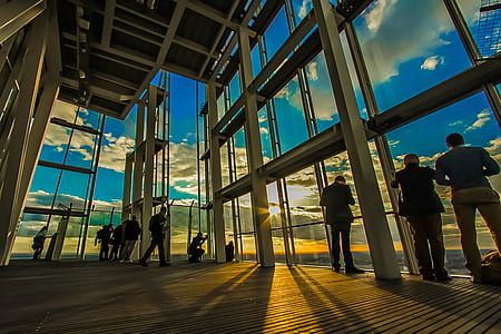 group of people standing on building with glass wall thumbnail