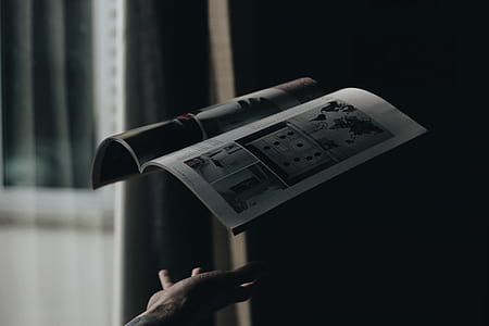 shallow focus photography of person throwing book thumbnail