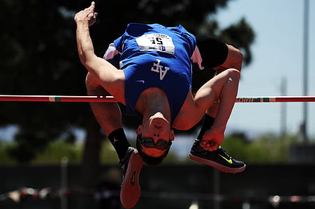 man wearing blue sleeveless shirt jump on stic k thumbnail