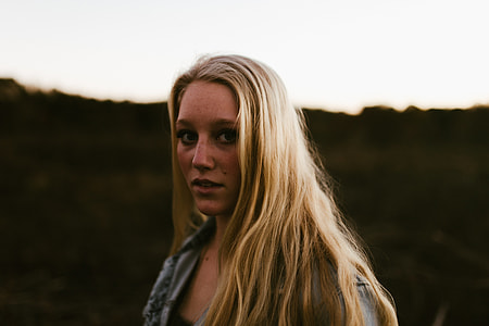 woman wearing gray top with blonde hair thumbnail