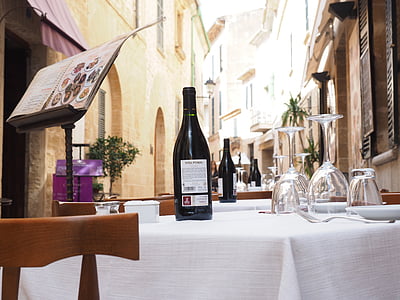 black and white wine bottle on white table cloth thumbnail