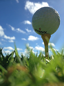 white golf ball surrounded by green grass thumbnail