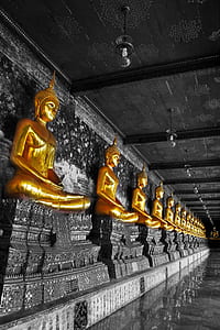 Buddha statues beside wall thumbnail