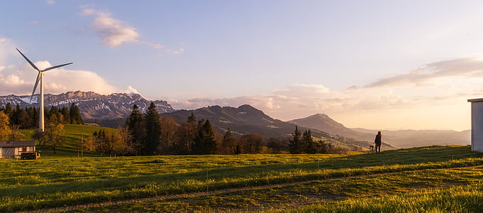 green grass field with mountain view during daytime thumbnail