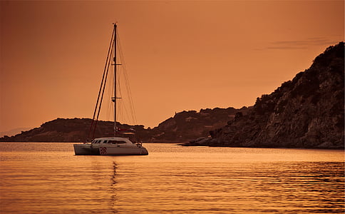 yacht cruising on body of water thumbnail