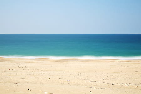 brown sand seashore during day time thumbnail
