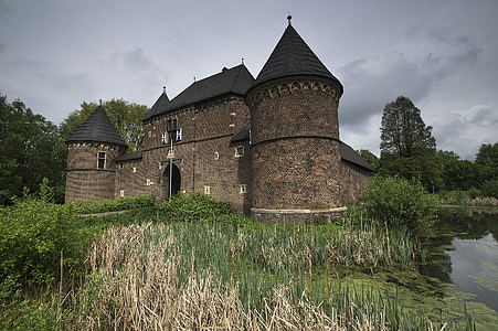 beige concrete castle surround by green grass thumbnail