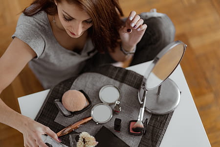 Young beautiful woman doing her make up thumbnail