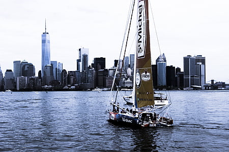 sailboat in body of water near city thumbnail