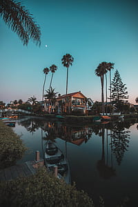 white and brown boat on body of water during nighttime thumbnail