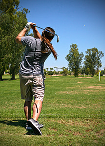 man playing golf under blue sky thumbnail