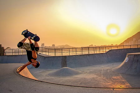 Man In Black Tank Top Skateboarding Wearing Helmet thumbnail