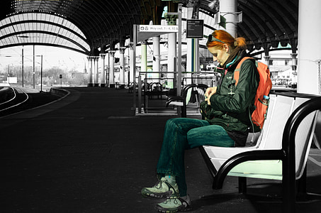 woman wearing orange backpack sitting on gang chair selective color photo thumbnail