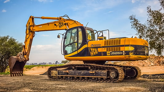 black and yellow front loader under blue sky thumbnail