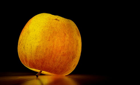 red apple fruit with light on table thumbnail