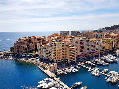 birds eye view of body of water beside orange buildings under white sky thumbnail