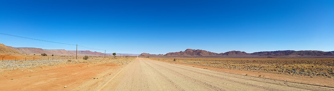 brown dirt road near mountain at daytime thumbnail